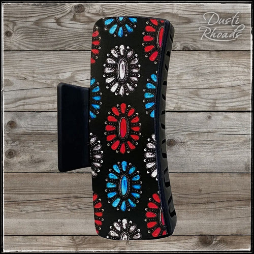 Black plastic hair clip with faux leather printed with red, white, and blue turquoise clusters.