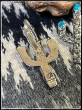 Load image into Gallery viewer, Del Arviso, Navajo silversmith. Tufa cast cactus pendants with a shepherd hook. Options come in coral or turquoise. - hallmark stamp.