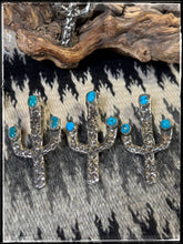 Load image into Gallery viewer, Del Arviso, Navajo silversmith. Tufa cast cactus pendants with a shepherd hook. Options come in coral or turquoise.