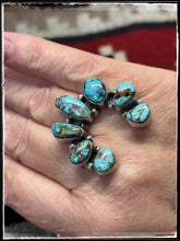 Load image into Gallery viewer, Donovan Skeets, Navajo silversmith. Sterling silver and Kingman turquoise Naja ring with an adjustable band. 
