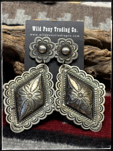 Leander Tahe, Navajo silversmith.  Sterling silver, mega concho earrings.