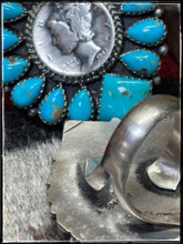 Load image into Gallery viewer, Annie Spencer, Navajo silversmith.  Sterling silver, Kingman turquoise, and a mercury dime cluster ring with an adjustable band.  Hallmark stamp. 
