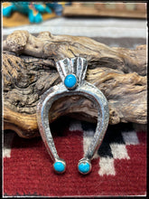 Load image into Gallery viewer, Del Areviso, Navajo silversmith.  Sterling silver and sleeping beauty turquoise on tufa cast Naja pendants with shepherd's hooks. Choice C.
