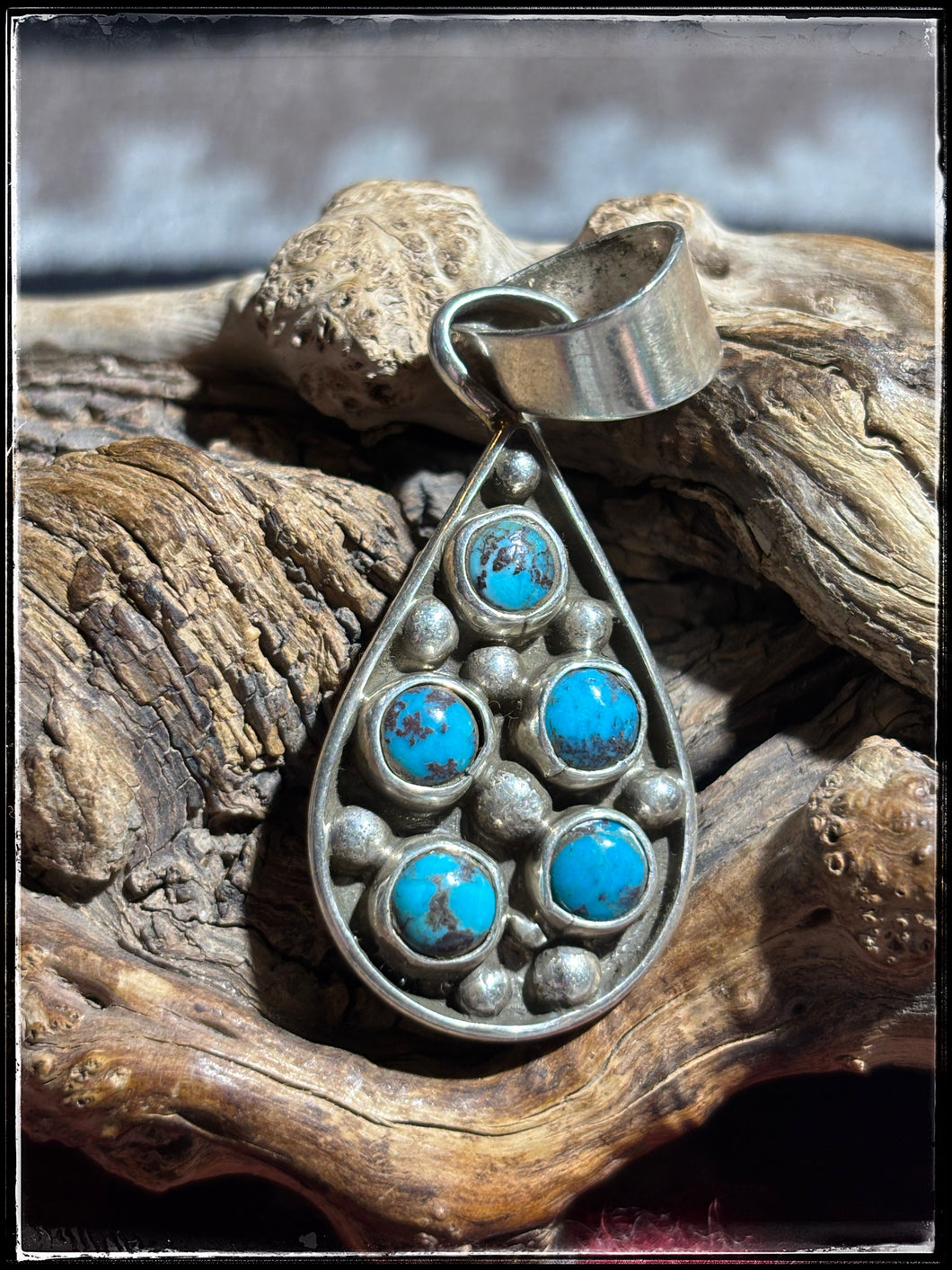 Priscilla Reeder, Navajo silversmith.  Sterling silver, turquoise and synthetic white opal double sided pendant.  