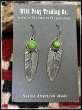 Load image into Gallery viewer, Sterling silver and Sonoran Gold turquoise feather earrings attributed to Ervin Hoskie. These are hallmarked and Navajo made. 
