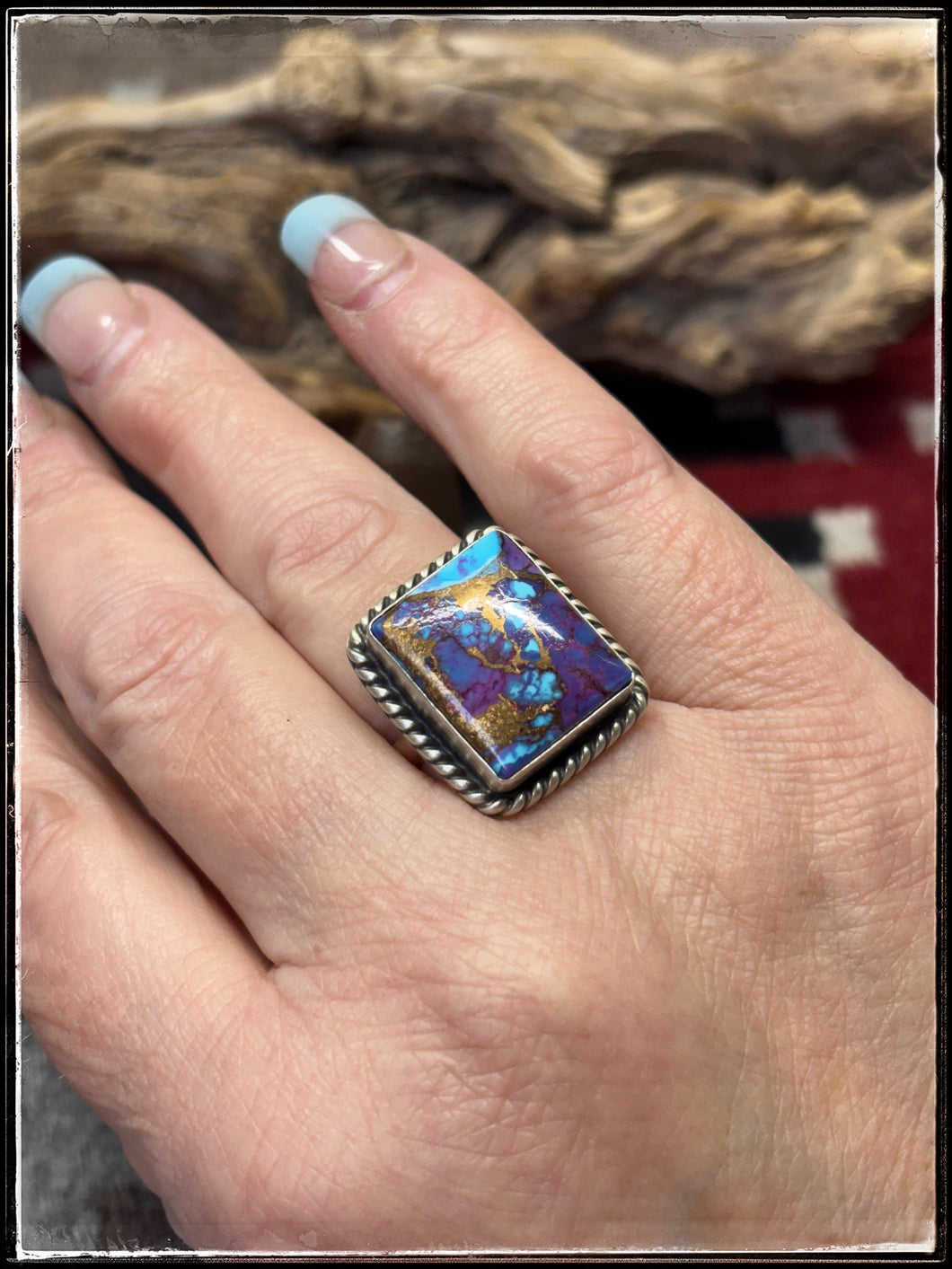 Donovan Skeets, Navajo silversmith.  Sterling silver and purple mojave composite stones with an adjustable ring band. 