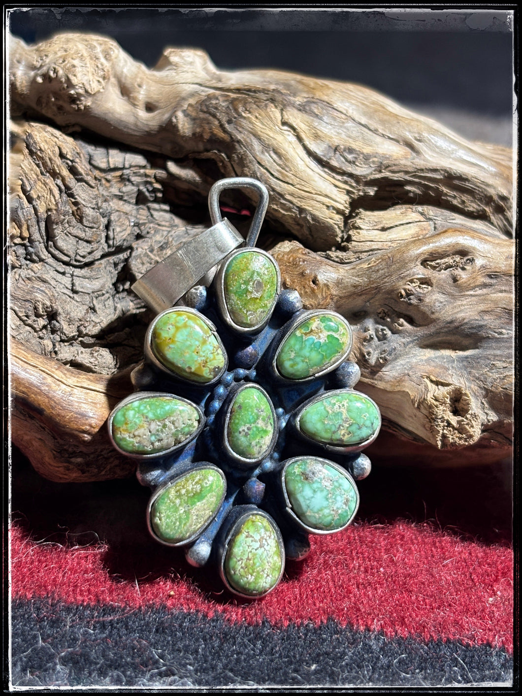 Travis Jim, Navajo silversmith.  Sterling silver and Golden Hills turquoise cluster pendant. 