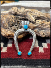 Load image into Gallery viewer, Del Areviso, Navajo silversmith.  Sterling silver and sleeping beauty turquoise on tufa cast Naja pendants with shepherd's hooks. Choice A. 
