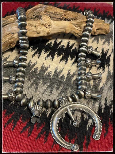 All sterling silver, handmade squash blossom necklace with center Naja from Navajo silversmith Presley Haley.