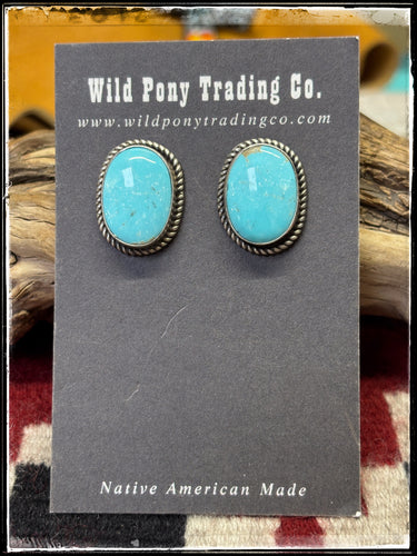 Judith Dixon, Navajo silversmith.  Sterling silver and Kingman turquoise, post style ova studs. 