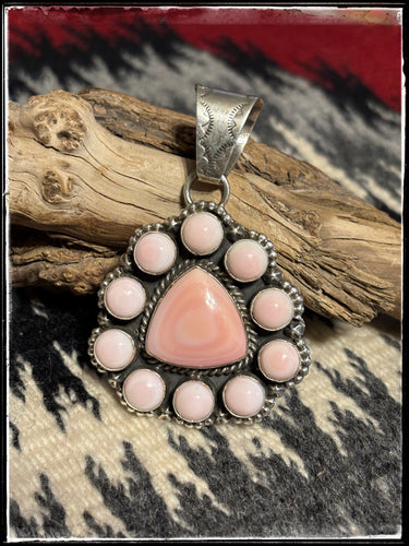 Pansy Johnson, Navajo silversmith., Pink conch cluster pendant set in sterling silver with an extra large bail.