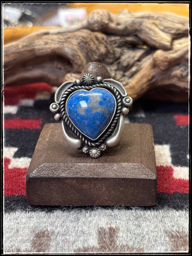 Ronald Tom, Navajo silversmith. Sterling silver and denim lapis heart shape stones. Rings have an adjustable band with stampwork. 