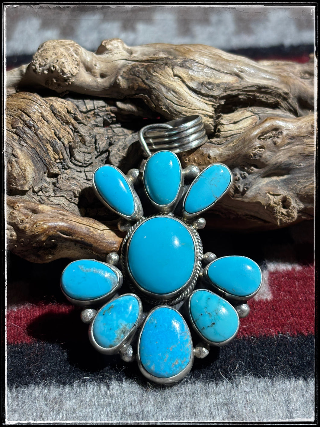 Sterling silver and turquoise cluster style pendant from Navajo silversmith Travis Jim. 