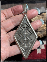 Load image into Gallery viewer, Stanford Yazzie, Navajo silversmith. Sterling silver tufa cast pendant. 
