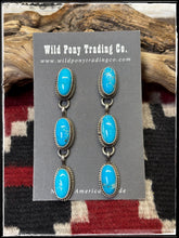 Load image into Gallery viewer, Freda Martinez, Navajo silversmith. Sterling silver and Kingman turquoise triple oval drop earrings. 
