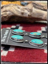 Load image into Gallery viewer, Freda Martinez, Navajo silversmith. Sterling silver and Kingman turquoise triple teardrop earrings. 
