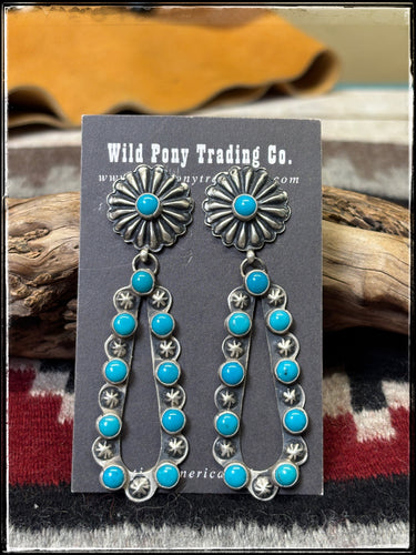 Eugene Charlie, Navajo silversmith.  Sterling silver and turquoise concho earrings.  