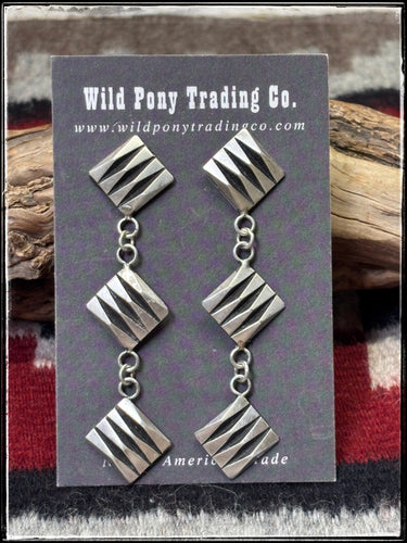 Leander Tahe, Navajo silversmith.  Sterling silver, overlay geo square dangles.  