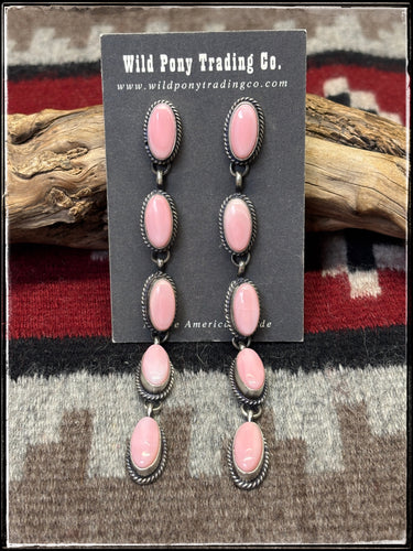 Freda Martinez, Navajo silversmith.  Sterling silver and 5 drop pink conch shoulder dusters. 