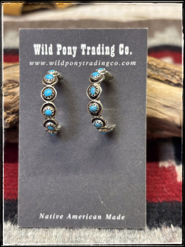 Sterling silver and turquoise hoops, handmade by Zuni artists. 