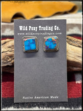 Load image into Gallery viewer, Judith Dixon, Navajo silversmith.  Sterling silver and Mojave turquoise (a composite) stud earrings. 
