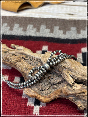 Double strand, bow bead bracelet.  Machine blown, sterling silver, 4mm beads. 