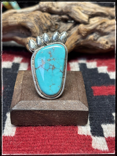 Del Arviso, Navajo silversmith.  Sterling silver and turquoise bear paw shaped ring with an adjustable band.  