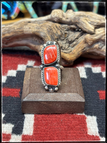 Eugene Belone, navajo silversmith.  Sterling silver and orange (almost reddish) spiny shell.  Adjustable band.  