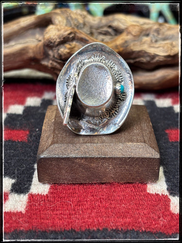 Robby Manuelito, Navajo silversmith.  Sterling silver hat ring with feather and turquoise stone accent. Has an adjustable band. 