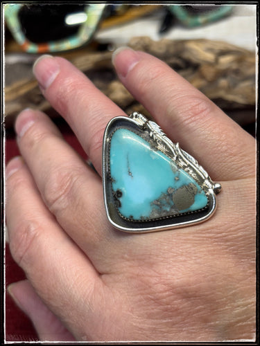 Del Arviso, Navajo silversmith. Sterling silver and turquoise ring with an adjustable tufa cast band. 