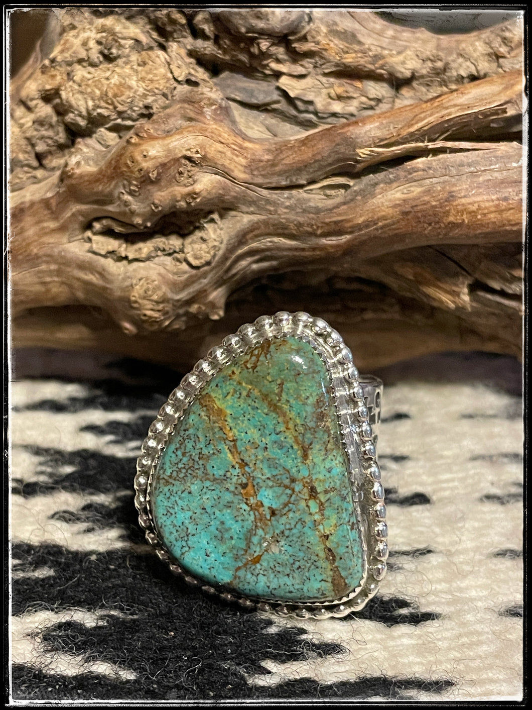 Del Arviso Navajo silversmith, large turquoise ring set in sterling silver with an extra wide, hand stamped band.