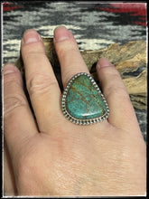 Load image into Gallery viewer, Del Arviso Navajo silversmith, large turquoise ring set in sterling silver with an extra wide, hand stamped band.
