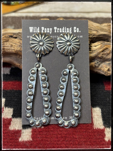 Pansy Johnson, navajo silversmith.  Sterling silver concho and starshot earrings. 