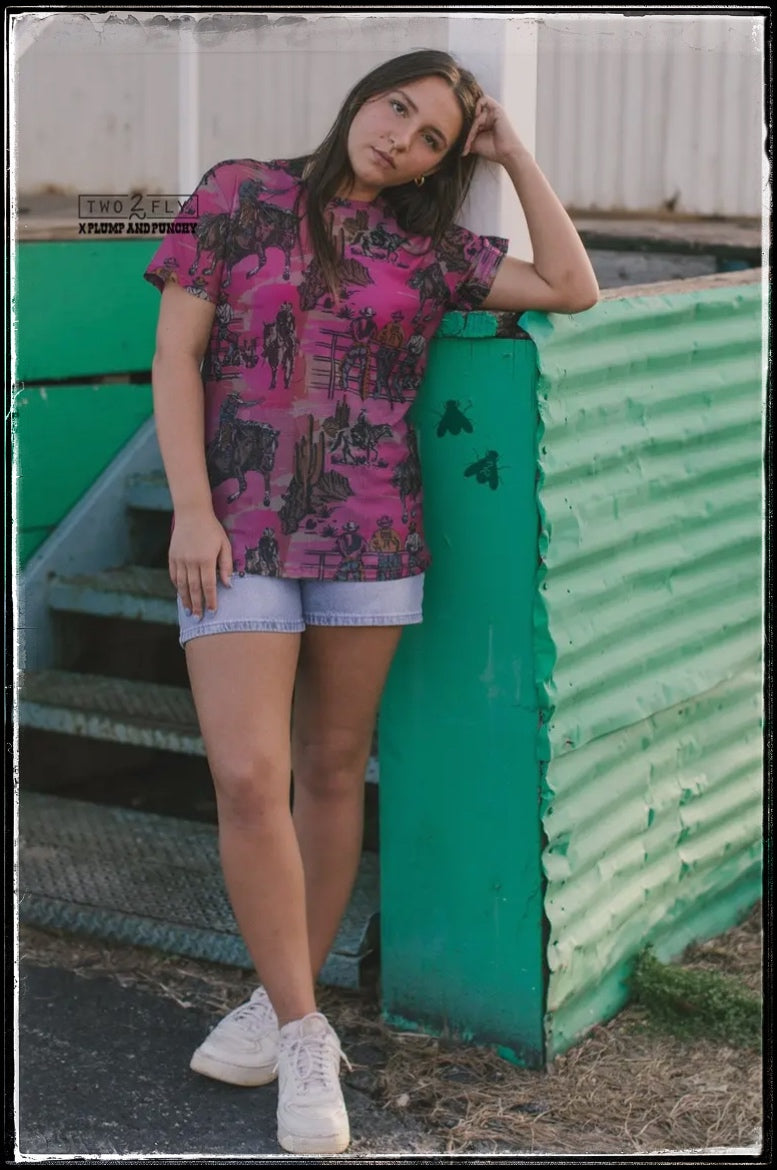 Hot pink, sheer top with a cowboy/western print. Comes with a pink half top cami.