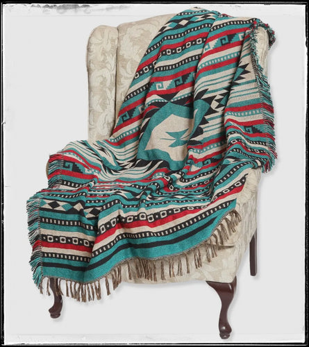 Cotton throw blanket with fringed edges. Bold, aztec print in teals, red, and black. 