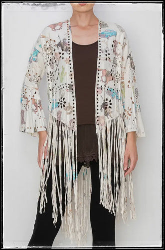 A faux suede poncho style top with western inspired images front and back. 