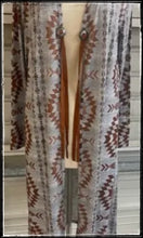 Load image into Gallery viewer, A gray and rust sweater in duster length with conchos and leather cord. 
