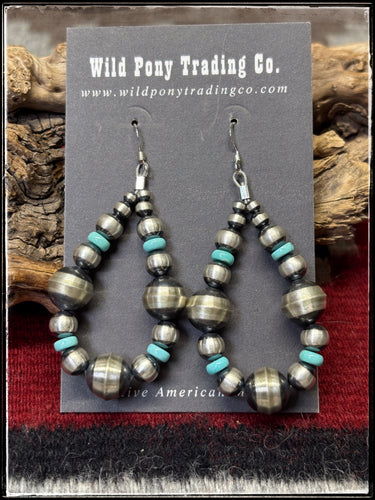 Sterling silver bench made beads along with machine blown beads and turquoise disc earrings. 