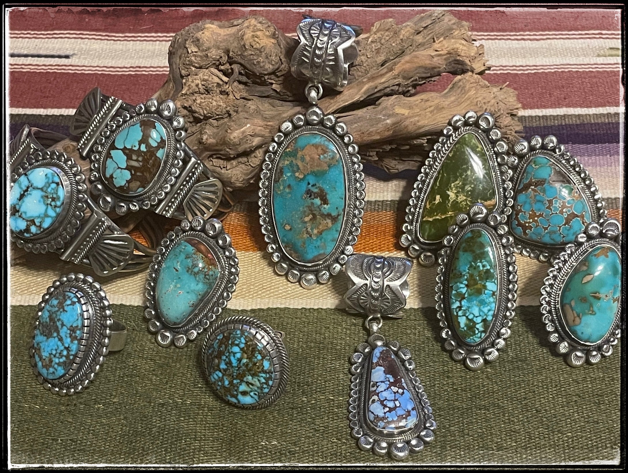 A collection of sterling silver and turquoise jewelry from Navajo silversmith Leon Martinez, including rings, pendants, and cuffs