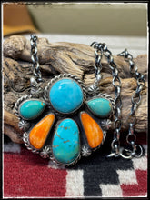 Load image into Gallery viewer, Augustine Largo, Navajo silversmith.  Sterling silver, Kingman turquoise stones, and orange spiny shell pieces set in a half cluster pattern. 
