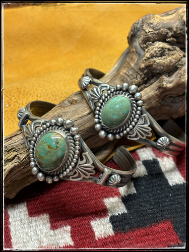 Mike Caladito, Navajo silversmith.  Sterling silver and Kingman turquoise cuffs.