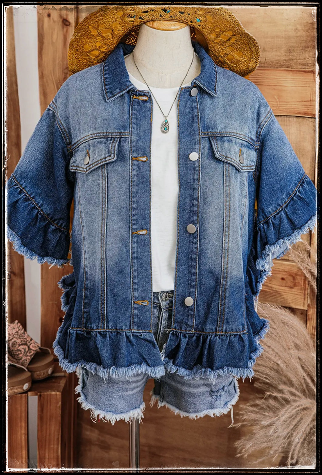 A cute denim jacket with ruffle 1/2 sleeves and raw edge hem.  