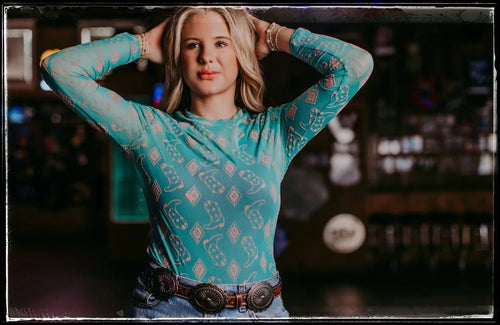 Turquoise cowboy boots and Aztec print mesh top.