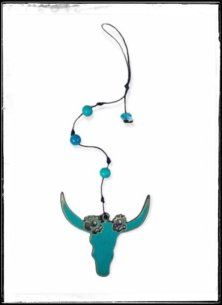 Metal buffalo skull ornament, painted turquoise with beads.  All recycled materials.
